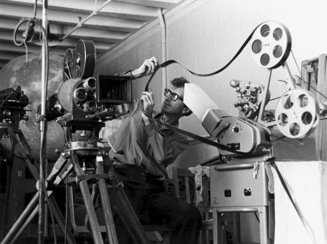Man editing film Because of modern technology, this man editing film on an old film editing machine is now a part of movie history