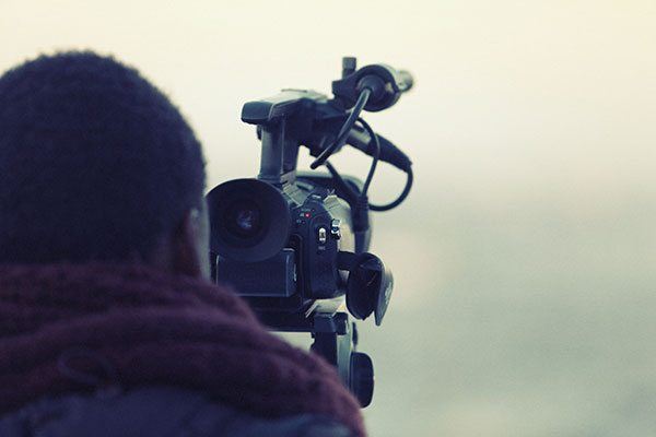 Man recording through a mini dv video camera