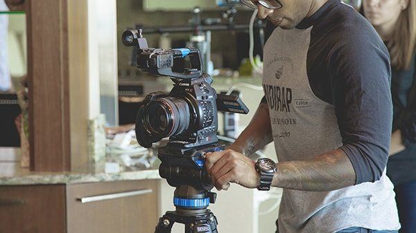 Man Shooting on DSLR Man shooting on a DSLR camera