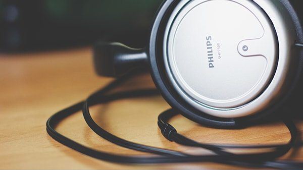 Phillips headphones resting on an editing table.