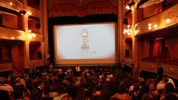 Dimly lit theatre full of people