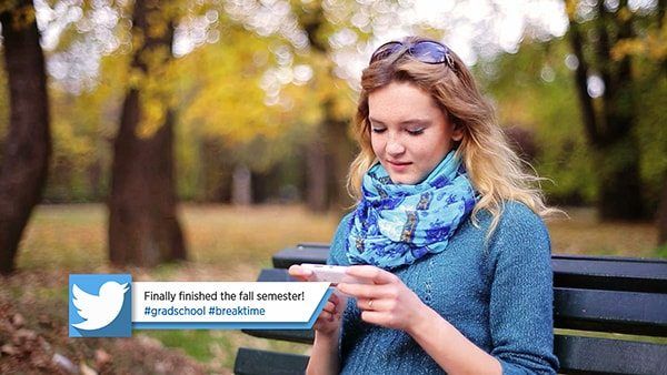 Young woman browsing social media in the park showing Twitter Lower Third