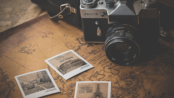 Camera Photo Photo of a vintage camera on a map with polaroids.
