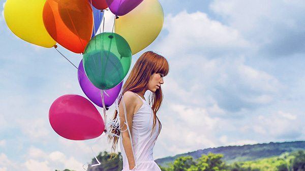 Color Corrector used on a woman with balloons walking in a field. ColorFast 2 filter applied to image.