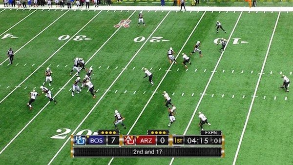 Wide shot of a football game and Karat scoreboard sample.