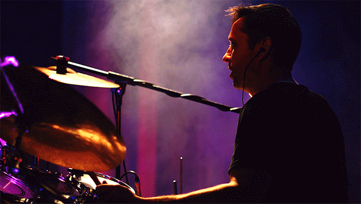 Light Leak video filter used on an image of a drummer playing an instrument during a live concert.
