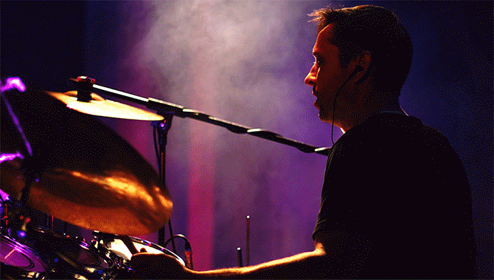 Filters 5 Light Leak Example Light Leak video filter used on an image of a drummer playing an instrument during a live concert.